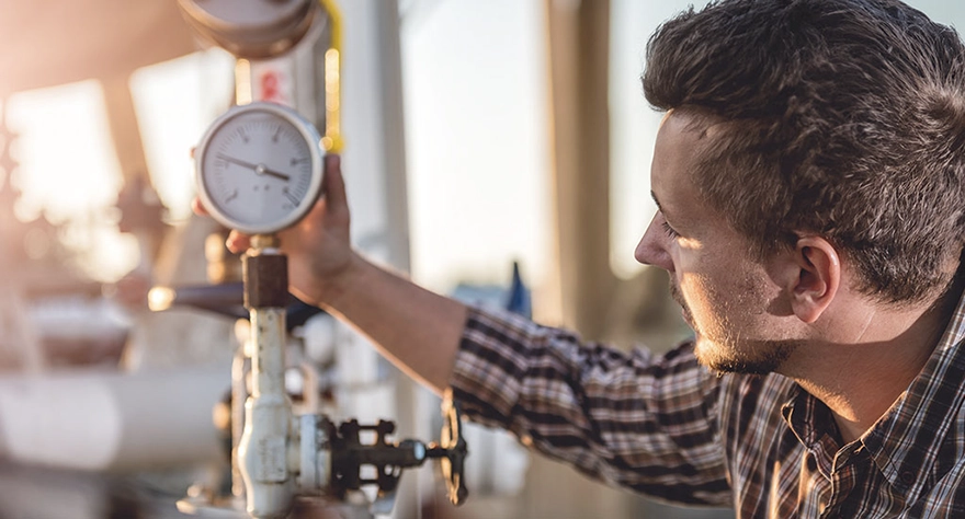 Employee checks gas valve